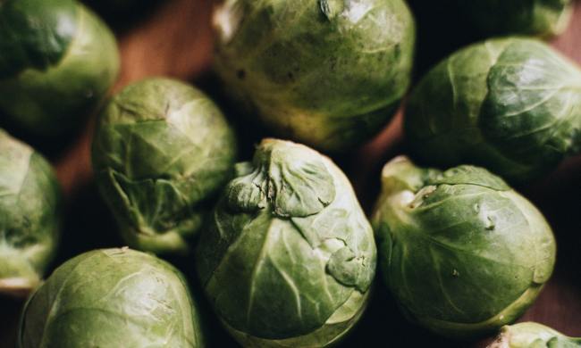 Whole brussels sprouts on a table.