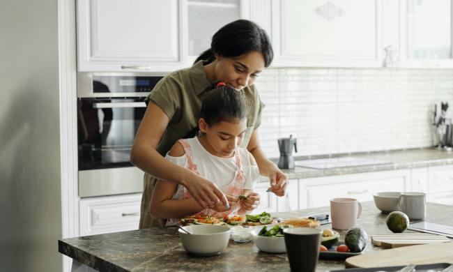 Mother and daughter cooking in the kitchen.