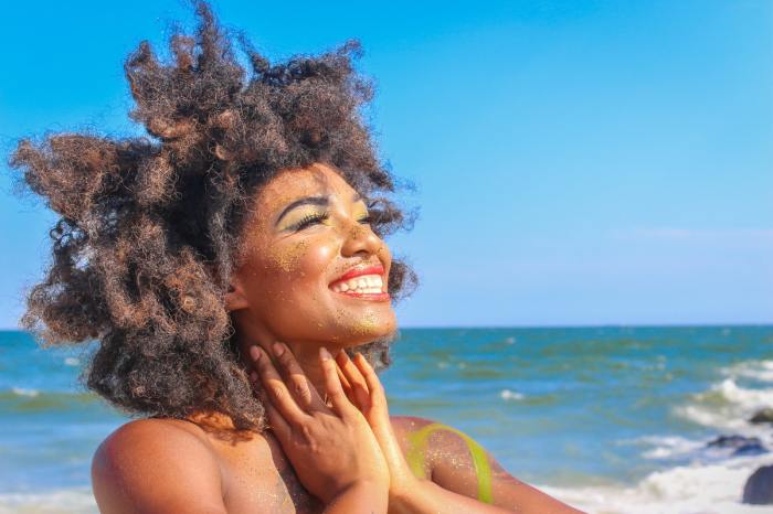 A woman enjoying the sunshine on the beach.