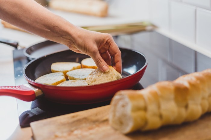 Person frying French bread in pan