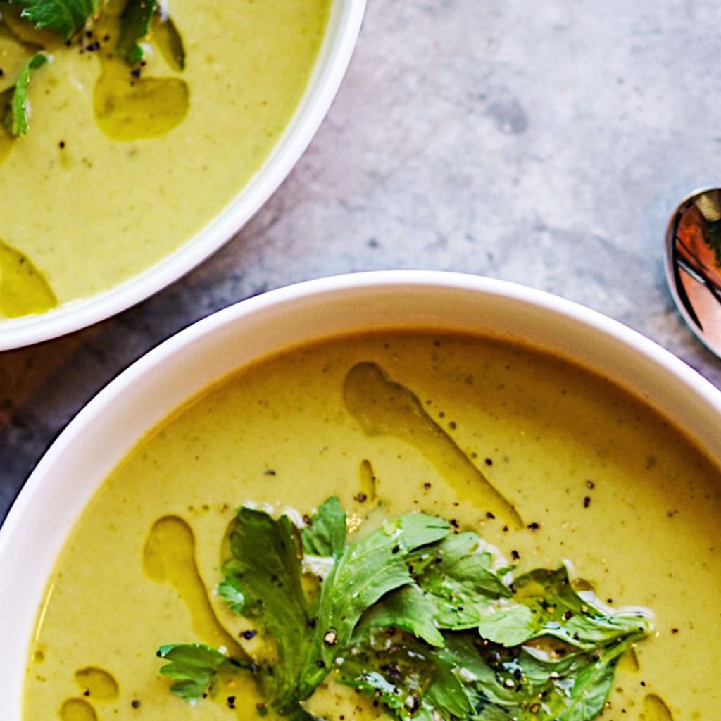 Two bowls of green soup