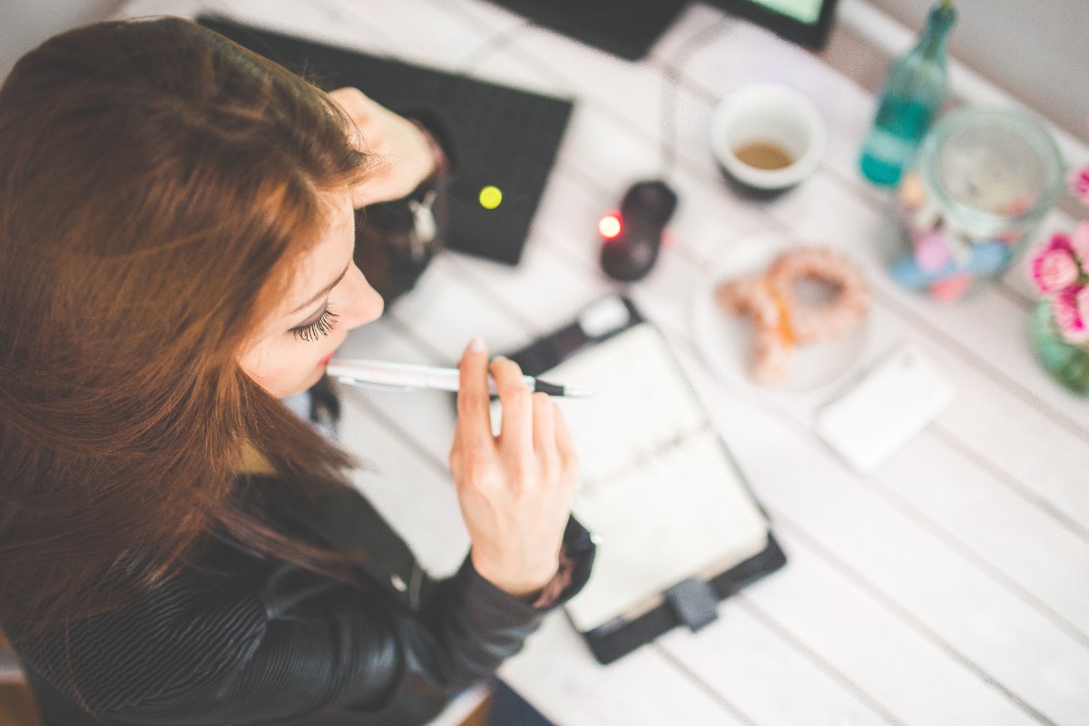 woman-at-desk-with-pen-thinking