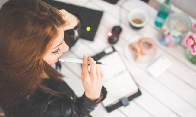 woman-at-desk-with-pen-thinking