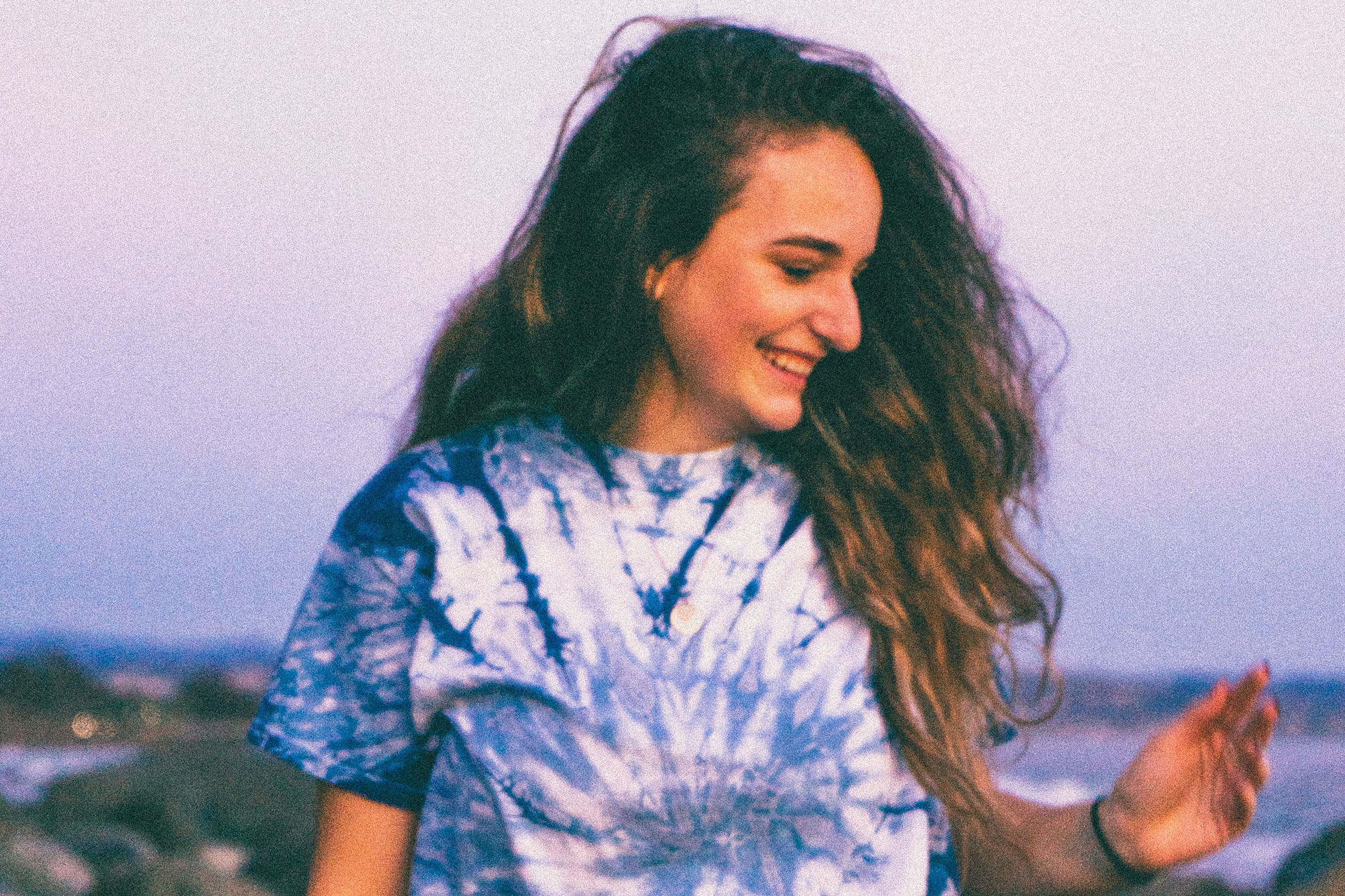 Woman wearing a blue and white tie dye shirt