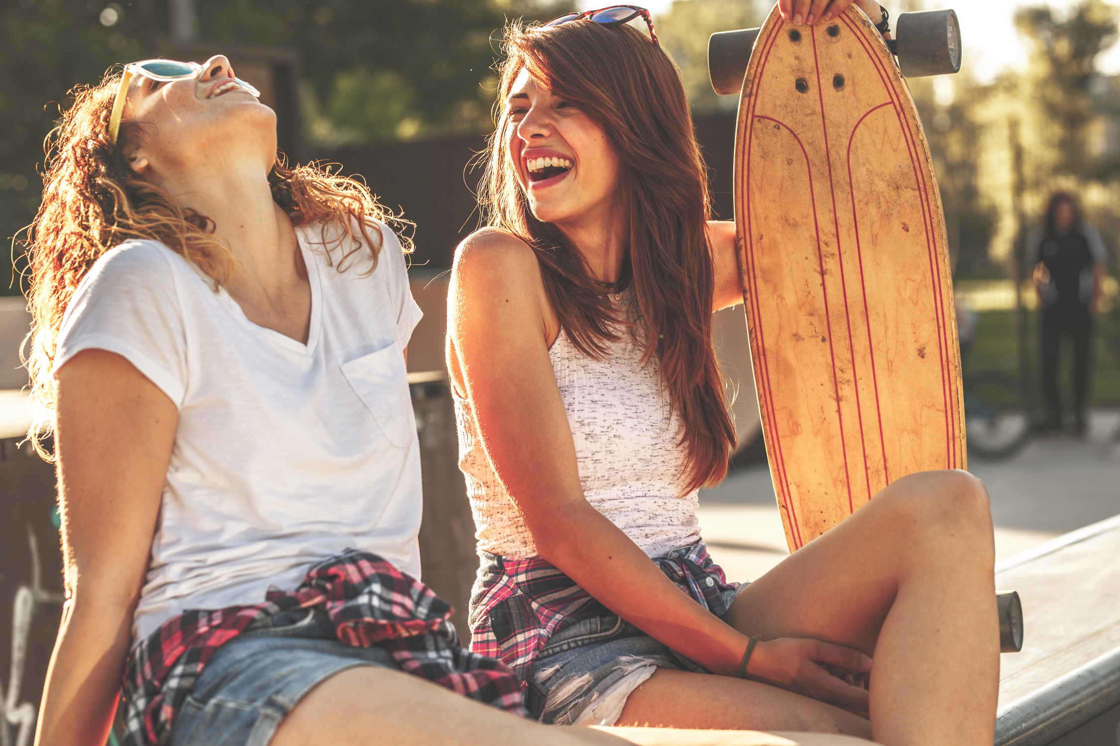 Two friends laughing at skate park