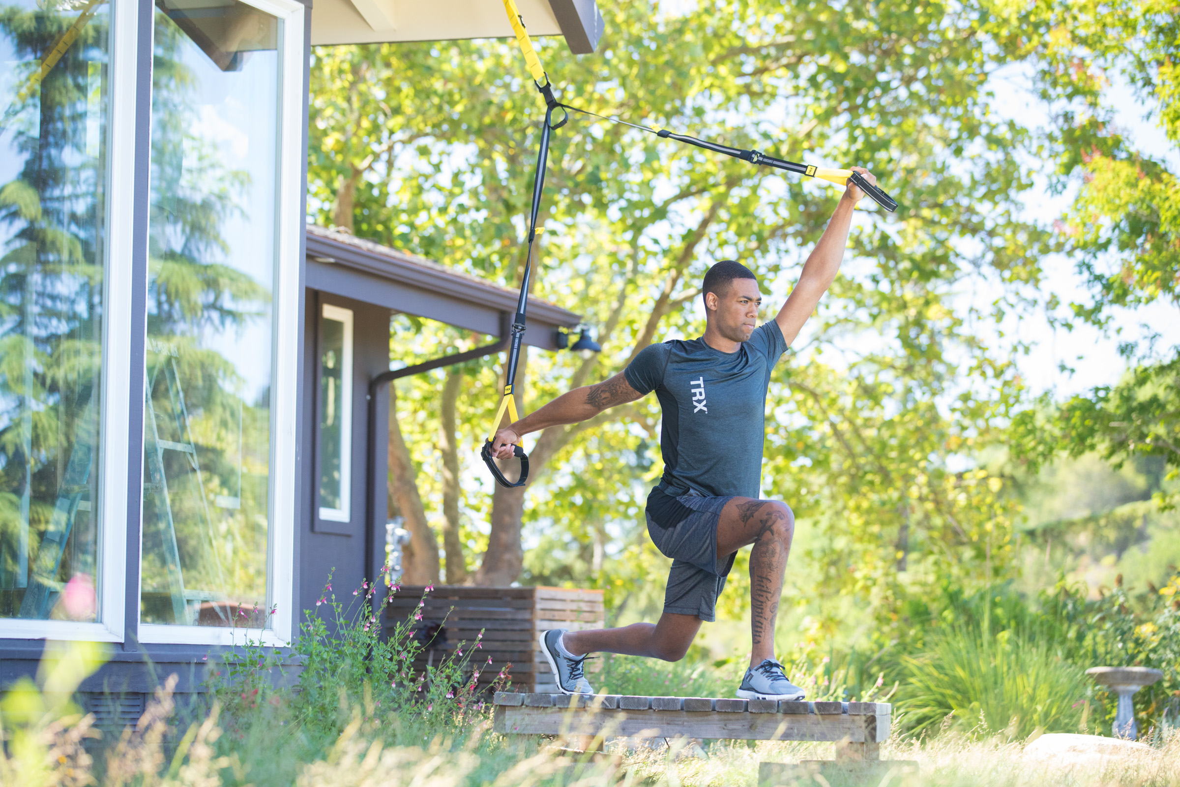 Man working out on porch with TRX