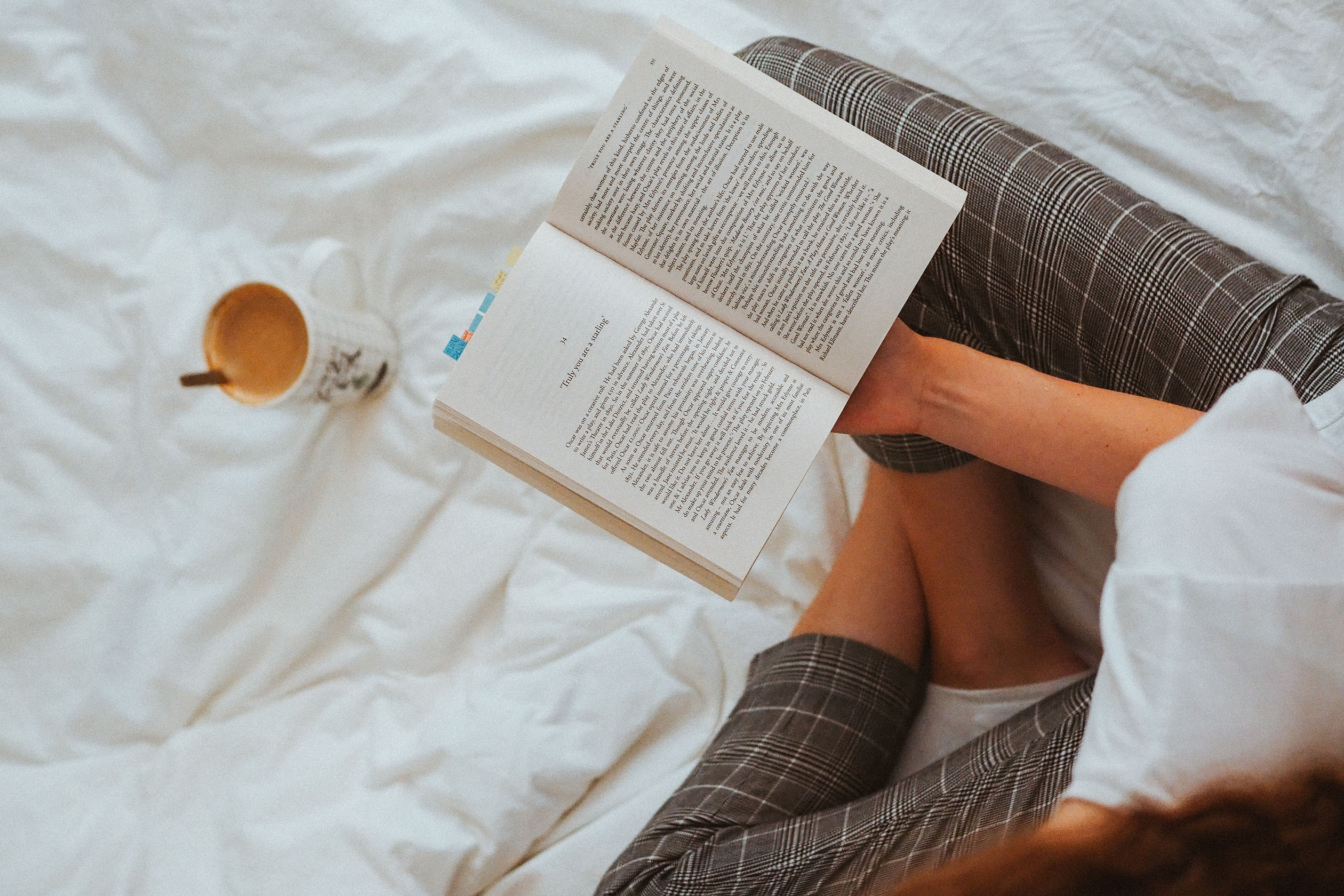 Woman reading a book in bed