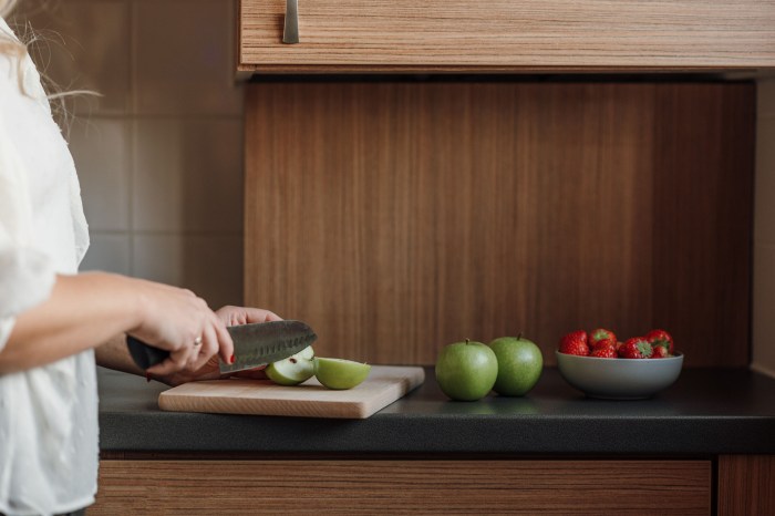 Woman slicing fruit in the kitchen