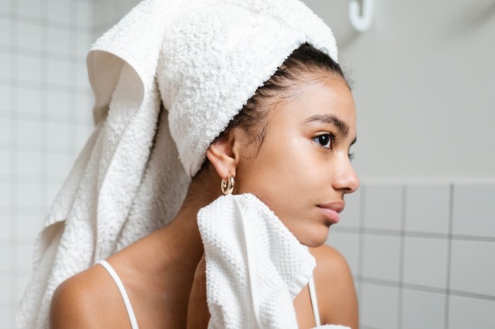 young woman wearing bath towel with smooth skin