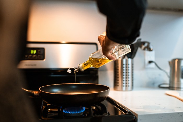 Person pouring cooking oil in a pan