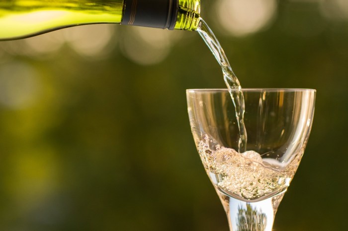 person-pouring-white-wine