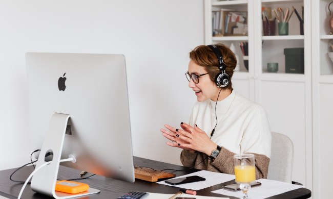 person in home office with headphones on