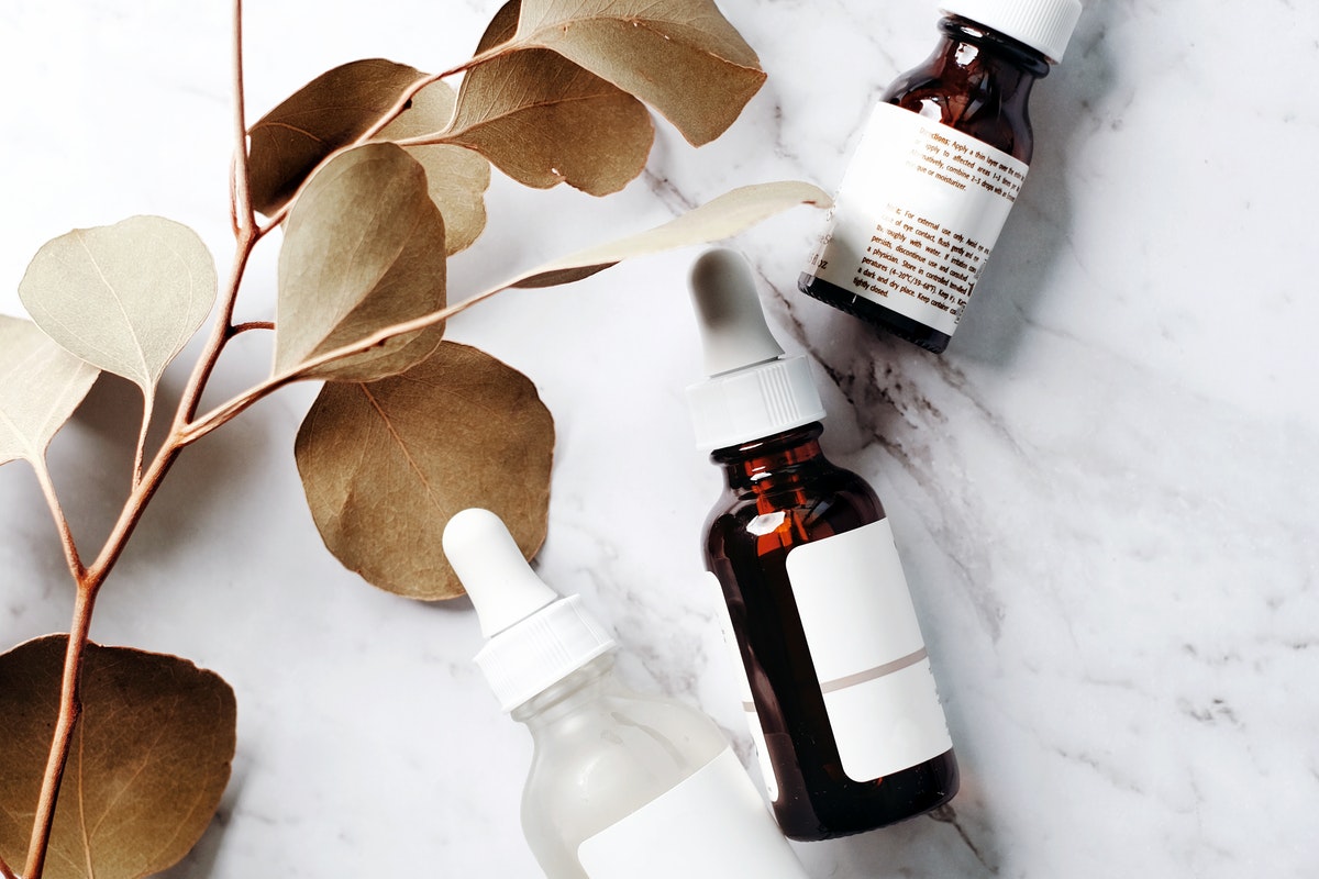 An array of oils and serums on a table.