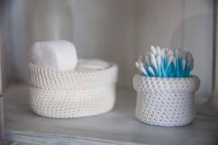 q tips in a white basket on bathroom counter