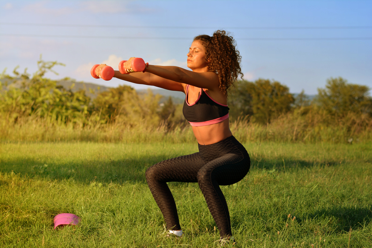 A woman working out outside.