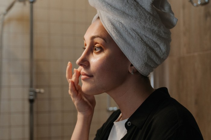 Woman applying a skincare product to her face