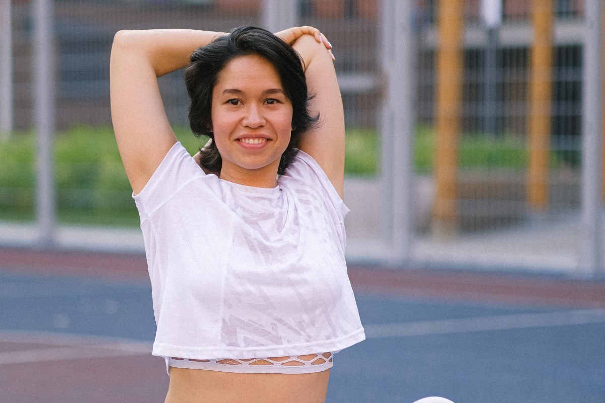 woman doing overhead tricep dip on track