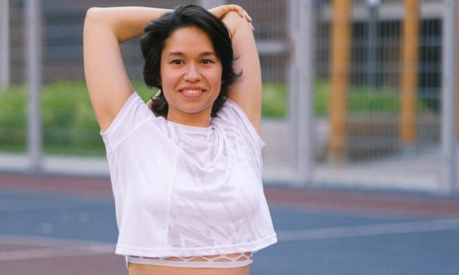woman doing overhead tricep dip on track