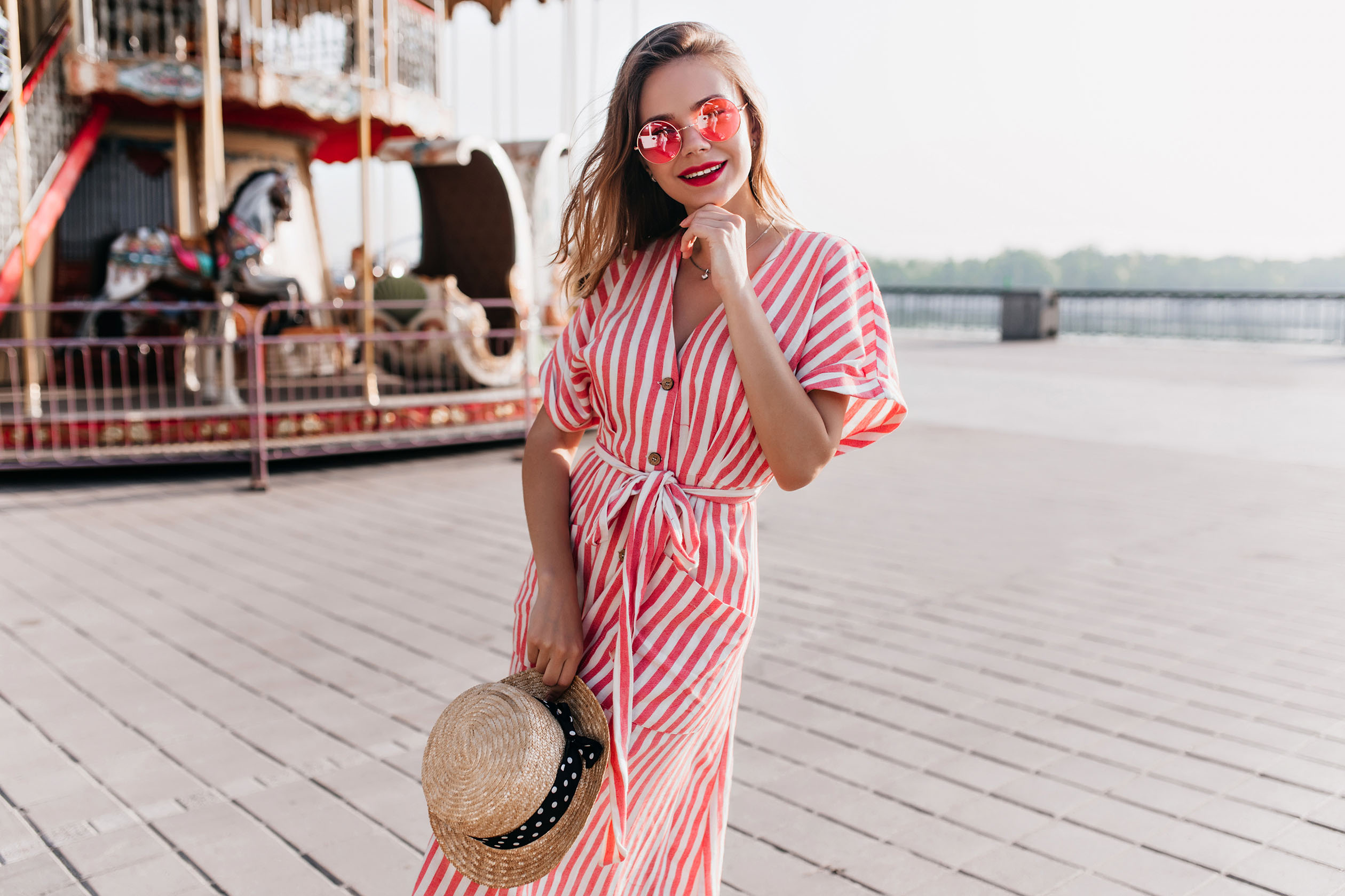 Woman in a striped dress with sunglasses and hat