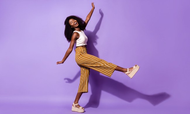 Woman wearing platform sandals on a purple background