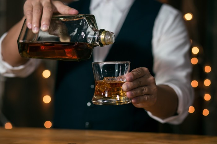 evidence based prevent hangovers bartender pouring bourbon