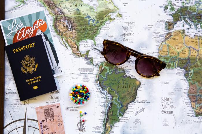 Passport on map with sunglasses