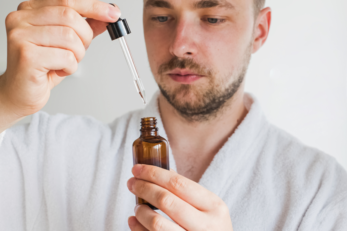 A man looking at beard oil.