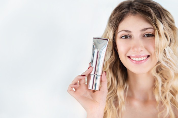 A woman holding up a primer by her face.