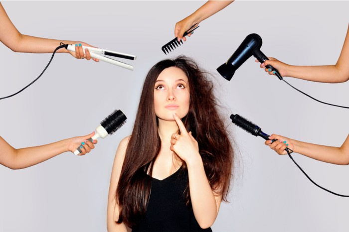 A woman looking at hair care tools that could be damaging her hair.