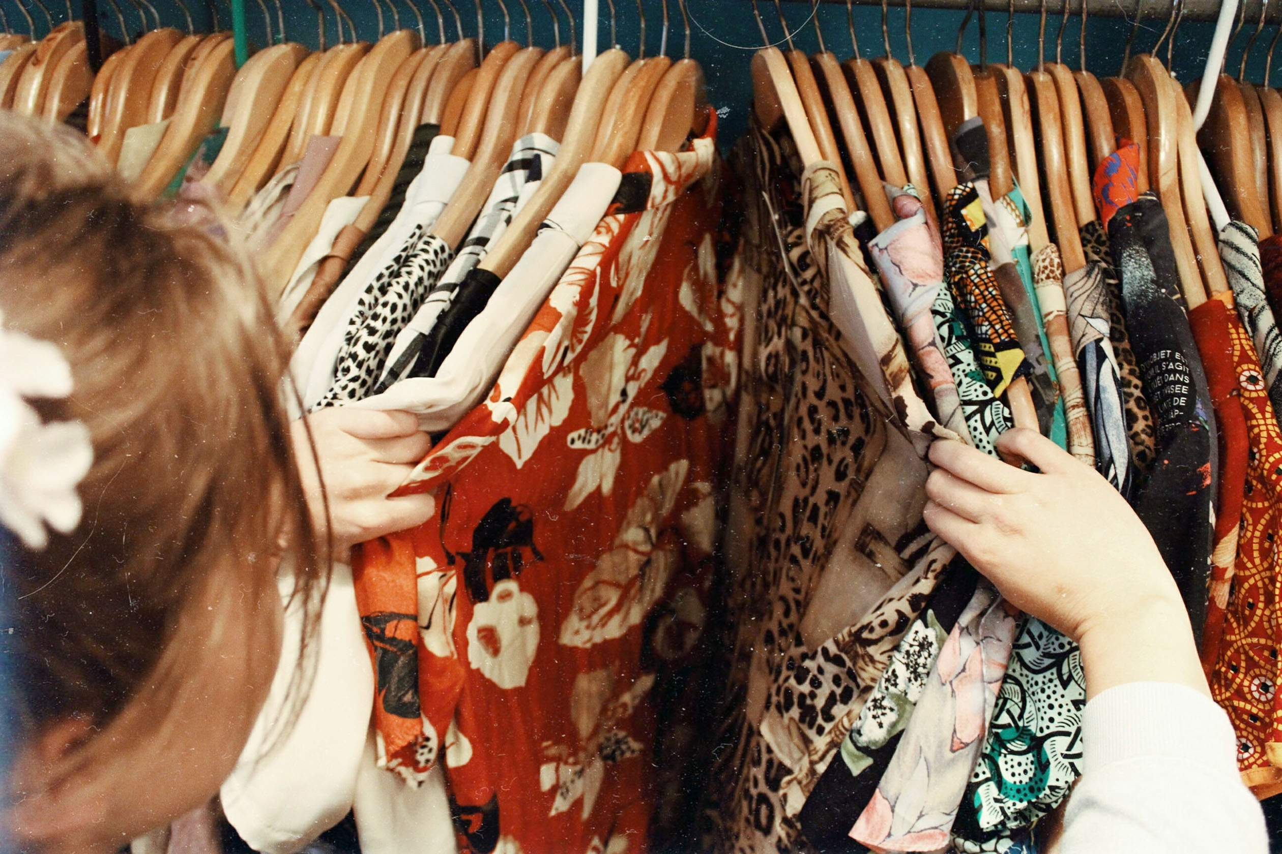 Woman browsing clothes at a thrift store