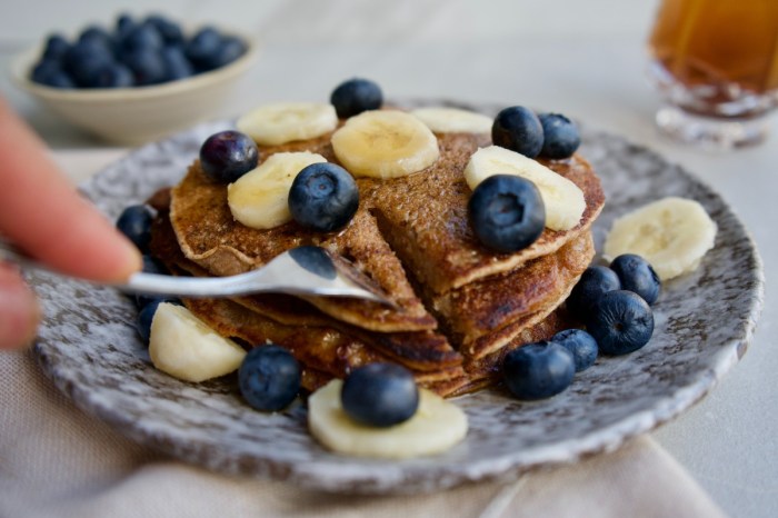 pancakes on a plate with berries and bananas