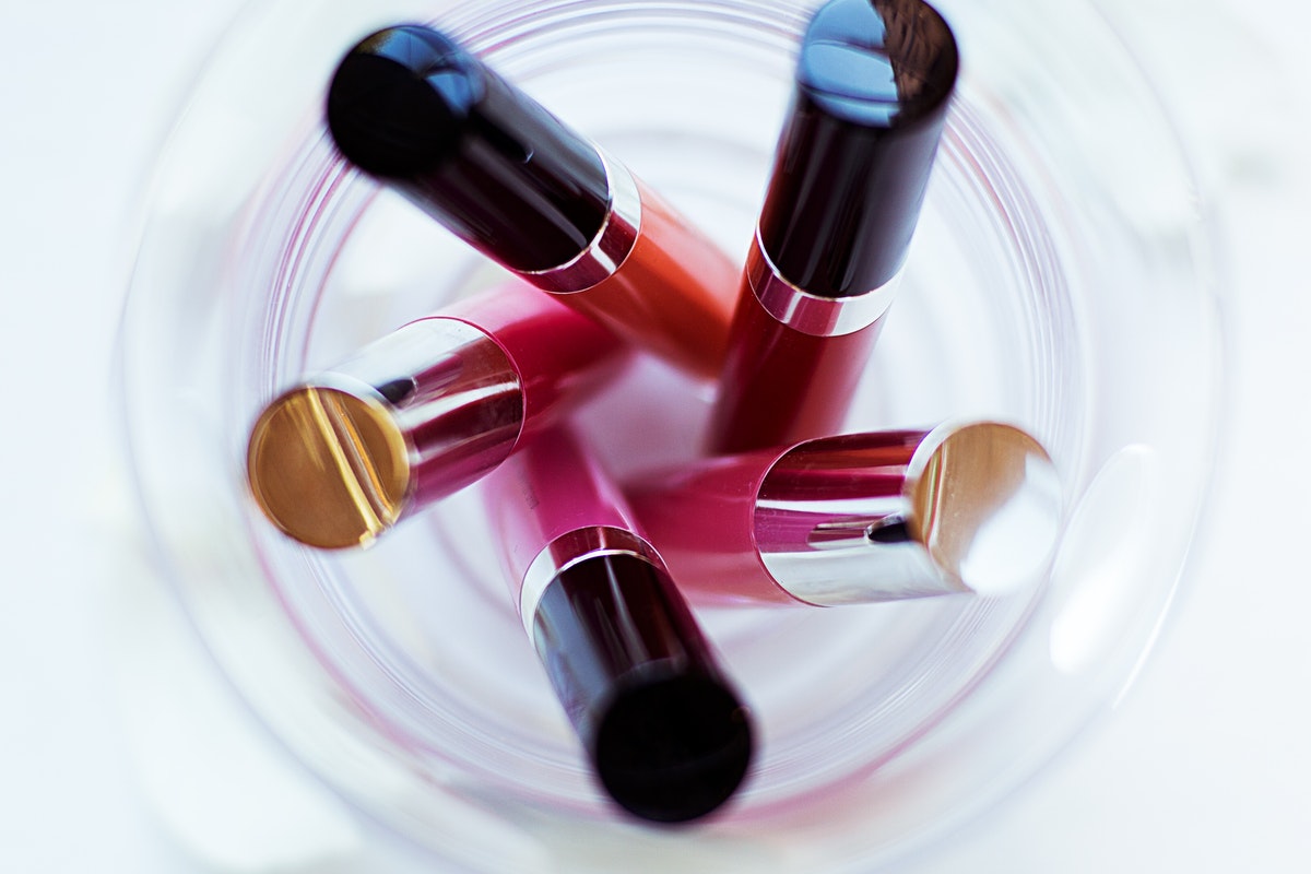 Lipsticks in a clear cup.