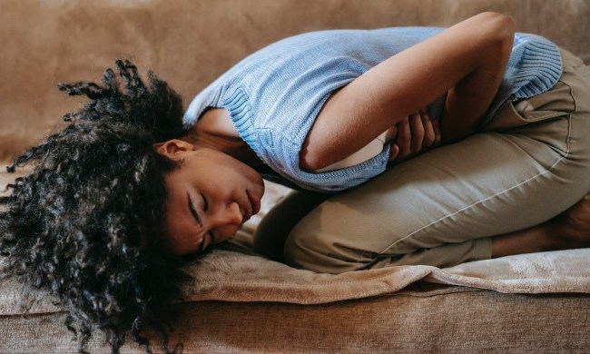 a woman on the couch with a stomach ache