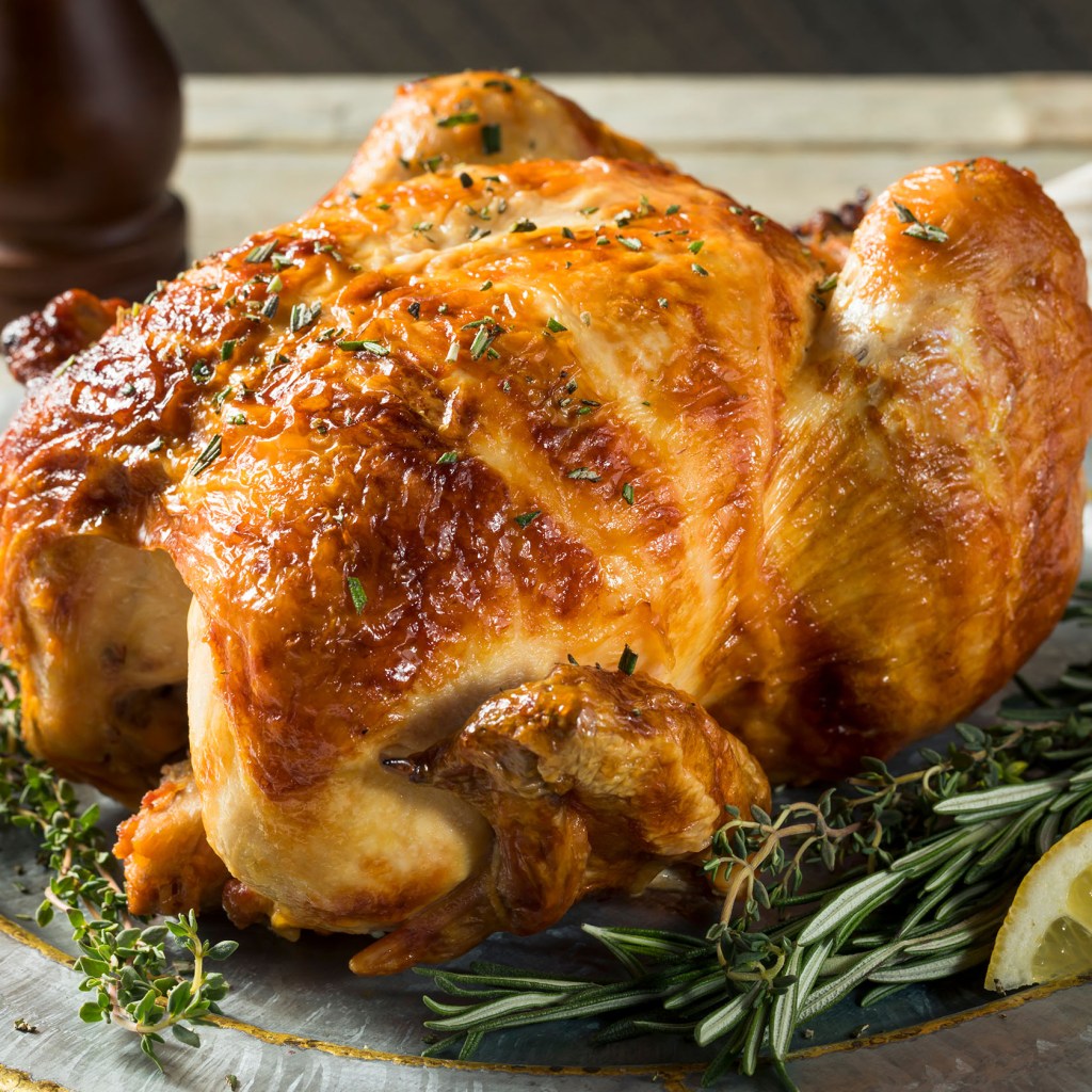 Rotisserie chicken on a plate with lemon