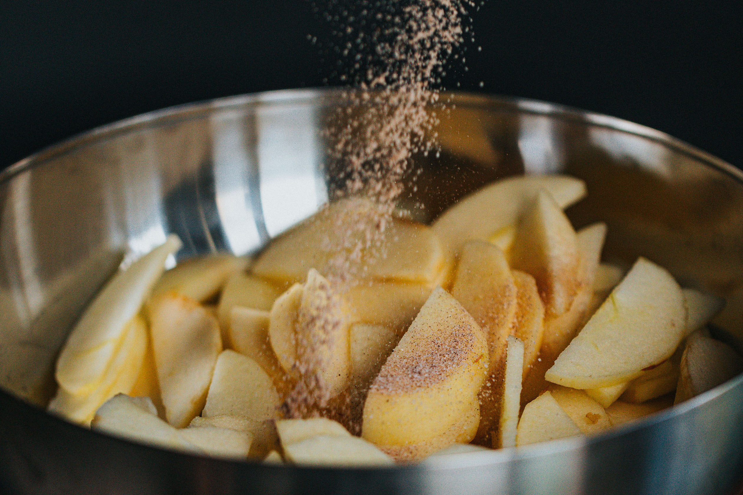 Seasoned apples in a metal bowl