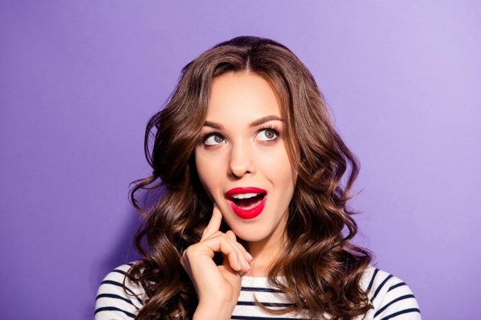 A woman wearing a bold red lipstick.