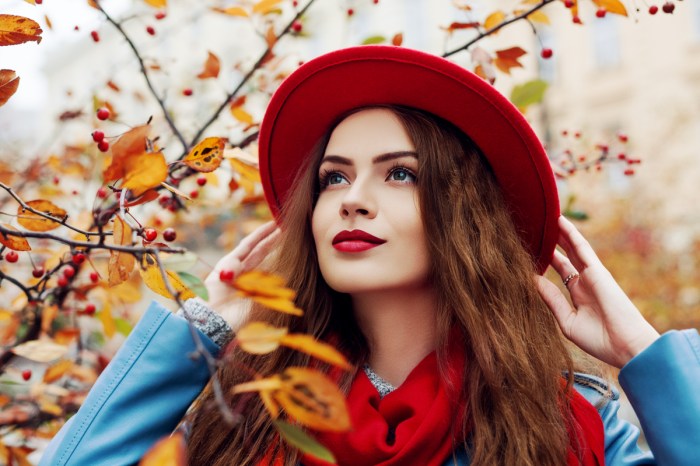 A woman in fall fashion and makeup.