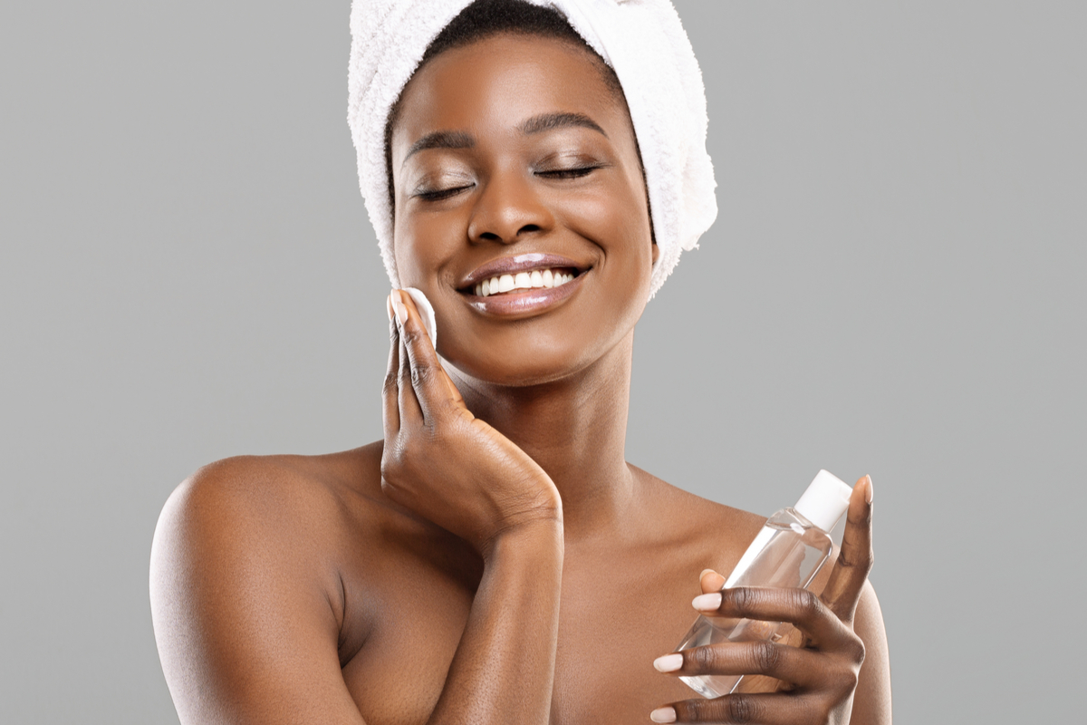 A woman using a face toner.
