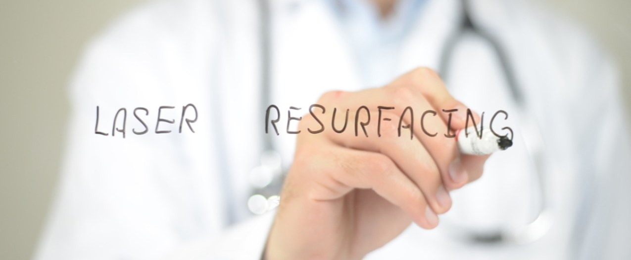 A doctor writing the words "laser resurfacing".