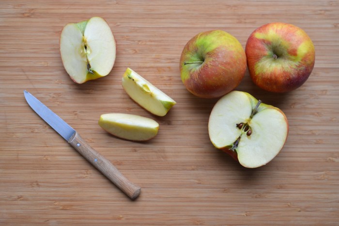 Sliced apples and knife on a cutting board