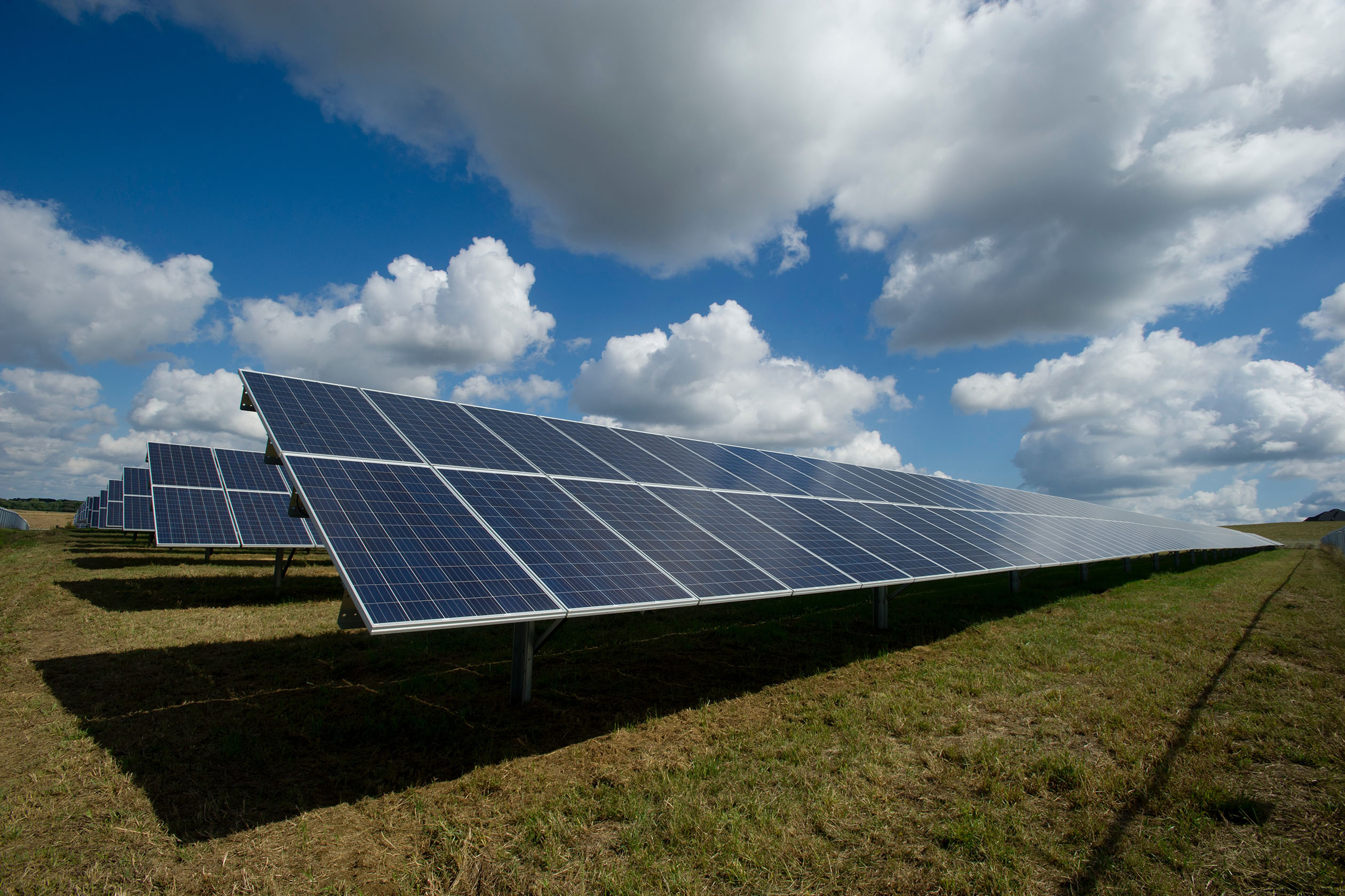 Solar farm with a partly cloudy sky