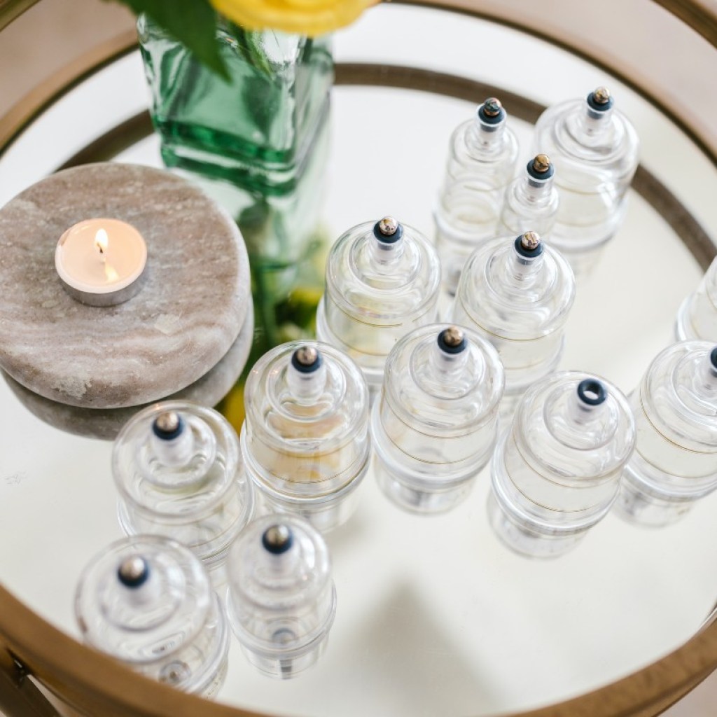 several suction cups for cupping next to a candle