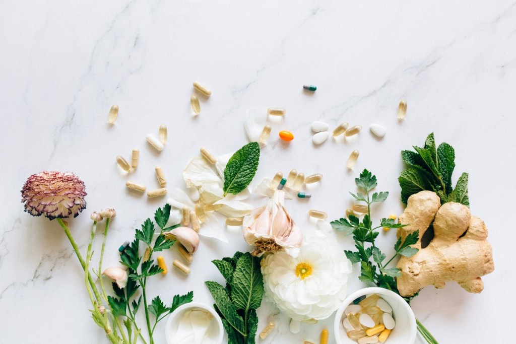 supplements on a white counter with plants