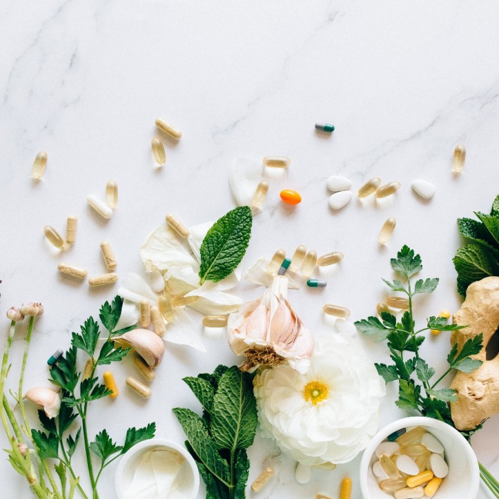 supplements on a white counter with plants