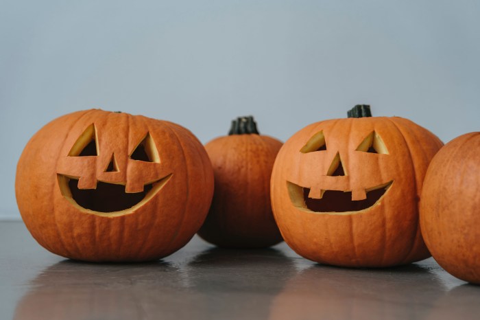Two jack-o-lanterns and pumpkins