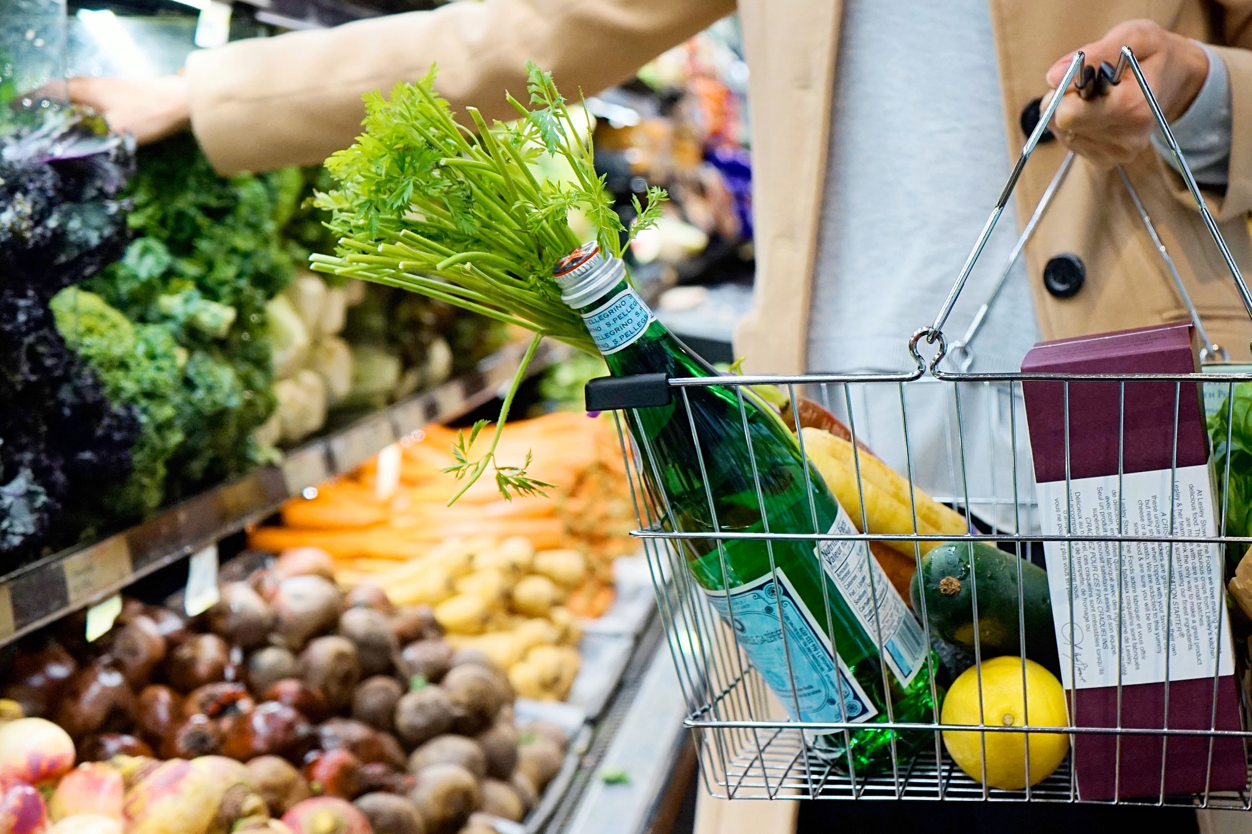 Woman grocery shopping with a full basket