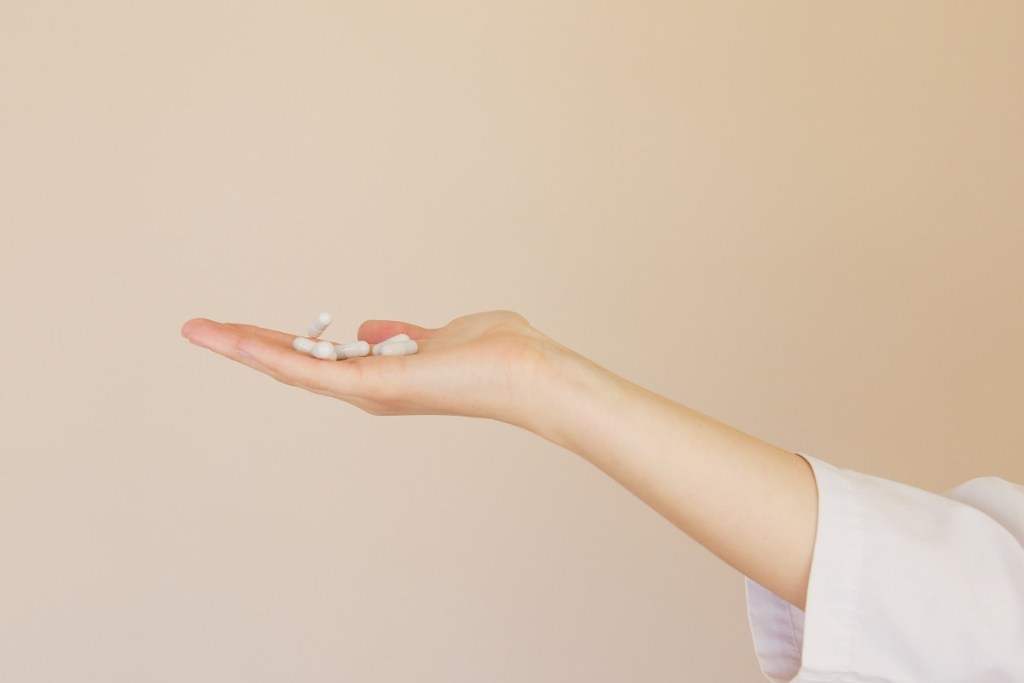 a woman holding herbal supplements