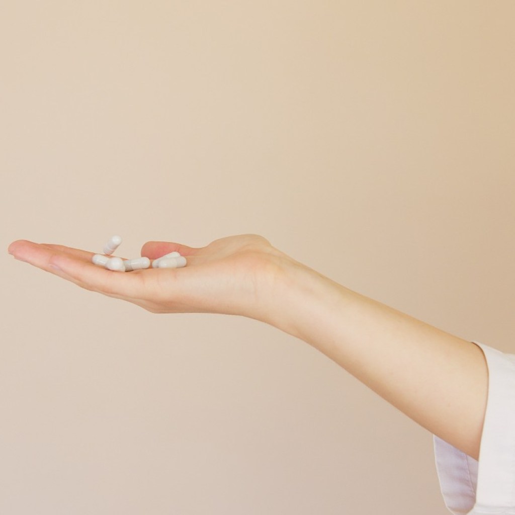 a woman holding herbal supplements