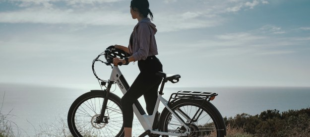 Woman on a bike overlooking the ocean
