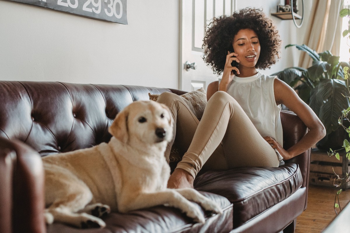 woman on couch with a yellow lab